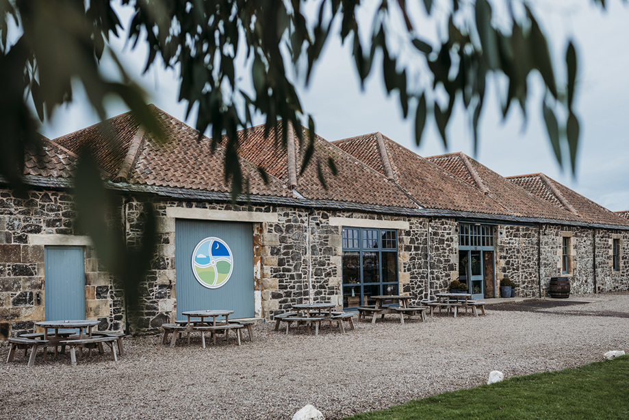 Pratis Barns exterior with round picnic tables